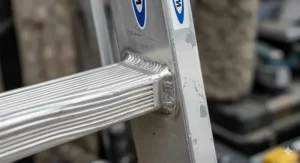 A close-up view of the high-grade aluminium stiles and slip-resistant rungs on a Werner trade ladder showing professional weld quality.