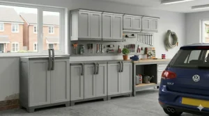 A series of modular plastic garage wall cabinets mounted above a workbench, showing a coordinated workshop storage system.