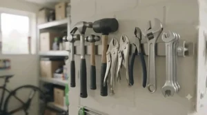 A heavy-duty magnetic tool holder supporting a range of heavy hammers and pliers in a compact shed.