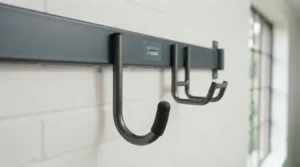 Close-up of heavy-duty steel wall hooks for organising garage tools.