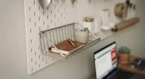 A small shelf attachment from the pegboard kit, ideal for displaying items in a home office.