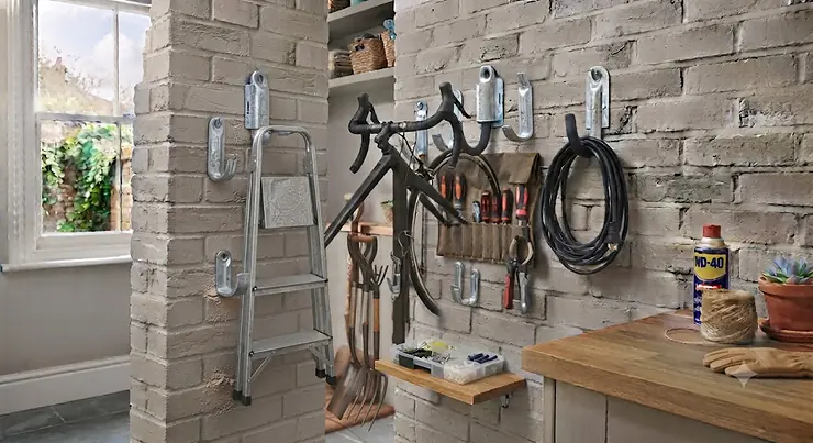Organised garage wall featuring multiple heavy-duty storage hooks. load bearing wall hooks