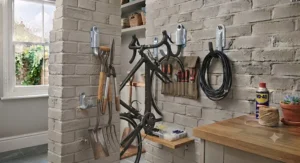 Large wall hook holding a spade and long-handled garden tools.
