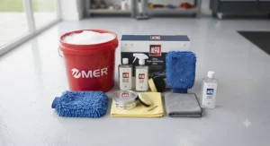 The contents of a beginner car wash and wax kit laid out flat, including shampoo, microfibre cloths, wax, and a wash mitt.