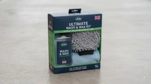 Lay flat view of a typical car wash and wax kit layout featuring a combination shampoo, wash mitt, and microfibre drying towel.