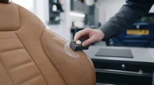Applying UV-protective cream to high-friction car seat side bolsters to prevent cracking and fading.
