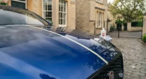 Applying all-in-one polish and wax to a vehicle bodywork with a microfibre applicator pad.