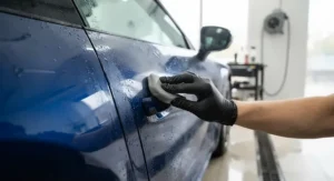 Rinsing and cleaning a car thoroughly before applying car polish for swirl marks to prevent further scratching.