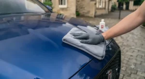 Before and after comparison showing paint restoration and gloss enhancement using an all-in-one car polish and wax.