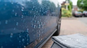 Water beading effectively on a car panel protected by a top-rated car wax under £20.
